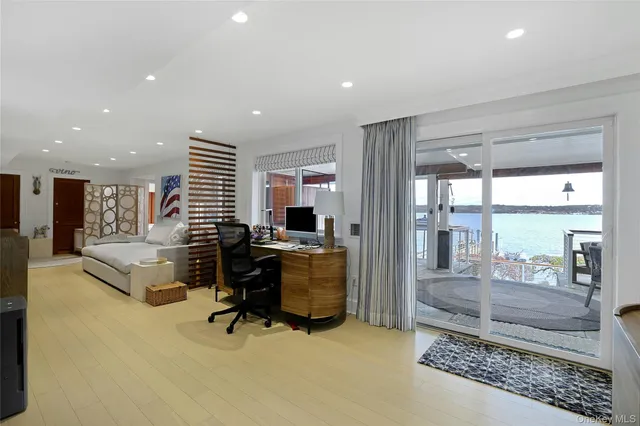 a living room with furniture and a floor to ceiling window