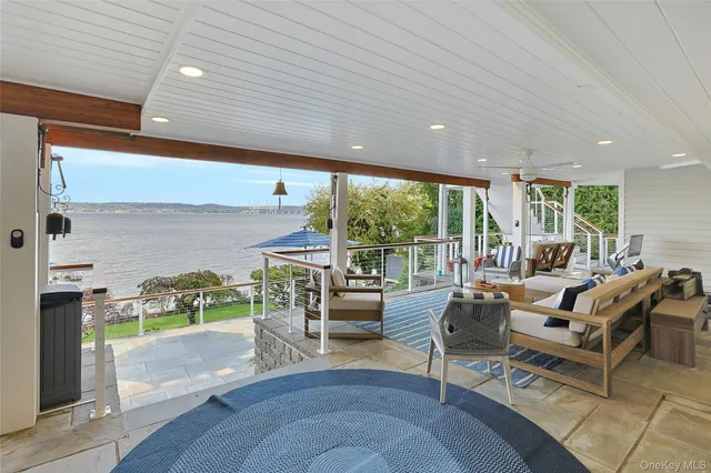 a view of a dining room with furniture large windows and wooden floor