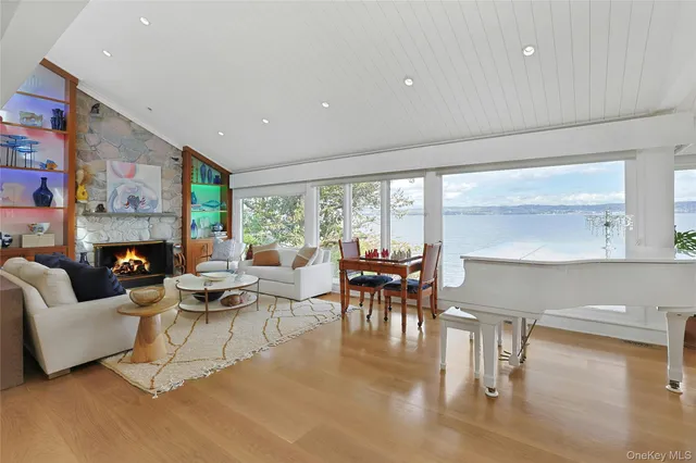 a living room with fireplace furniture and a large window