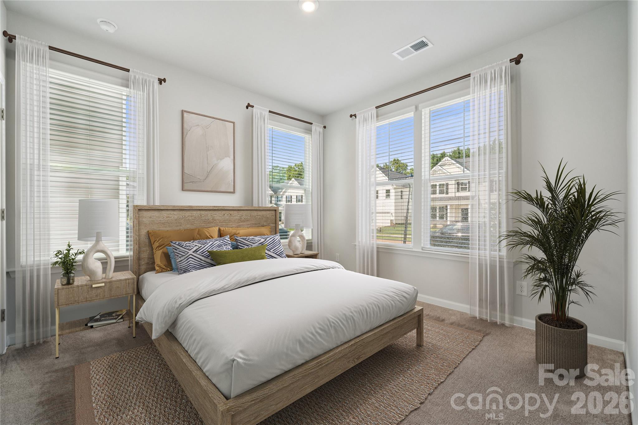 415 Alameda Way Matthews, NC 28104 - Photo 11 of 33 a bedroom with a large bed and a potted plant