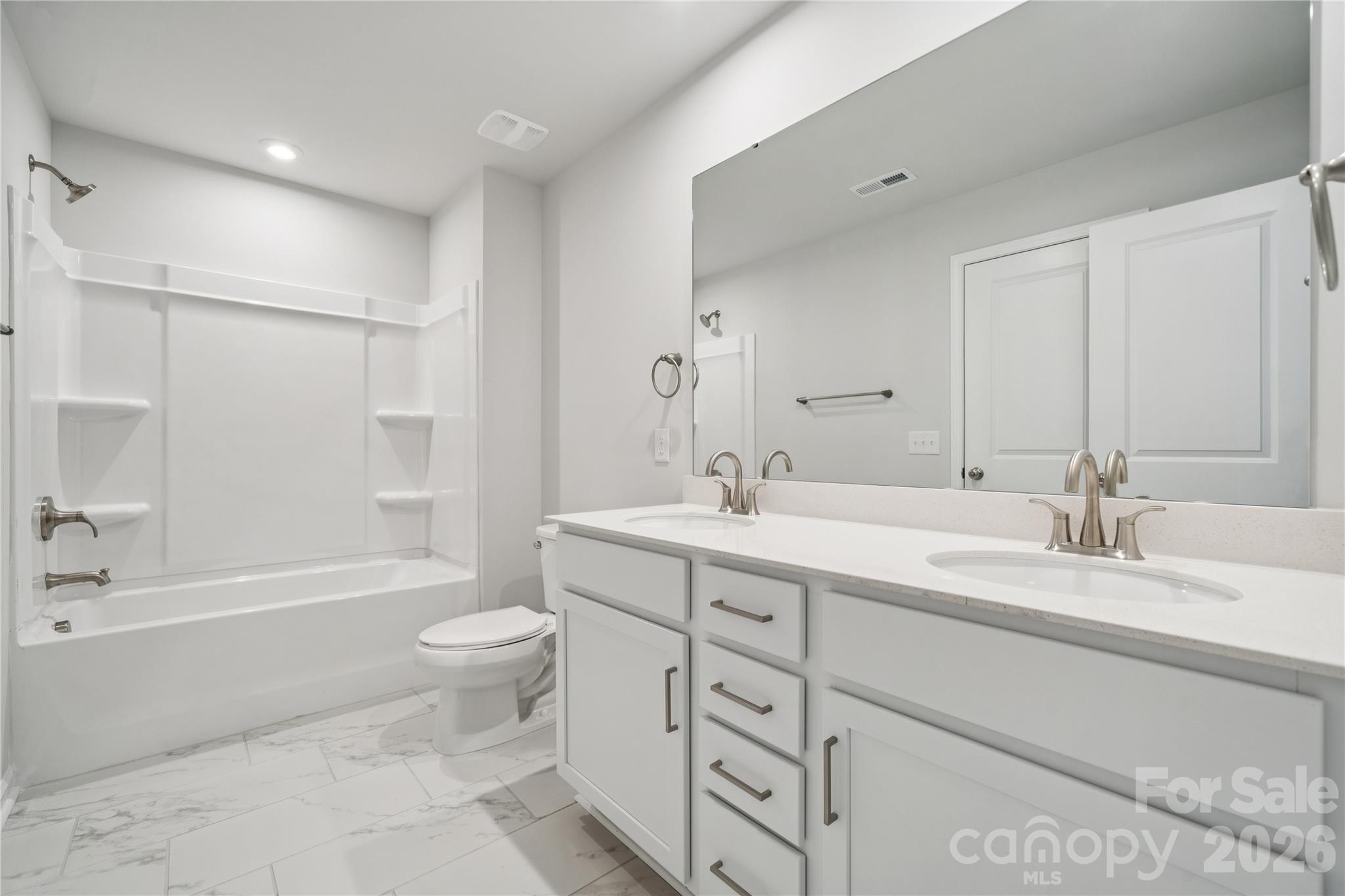 415 Alameda Way Matthews, NC 28104 - Photo 14 of 33 a bathroom with a double vanity sink toilet mirror and bathtub