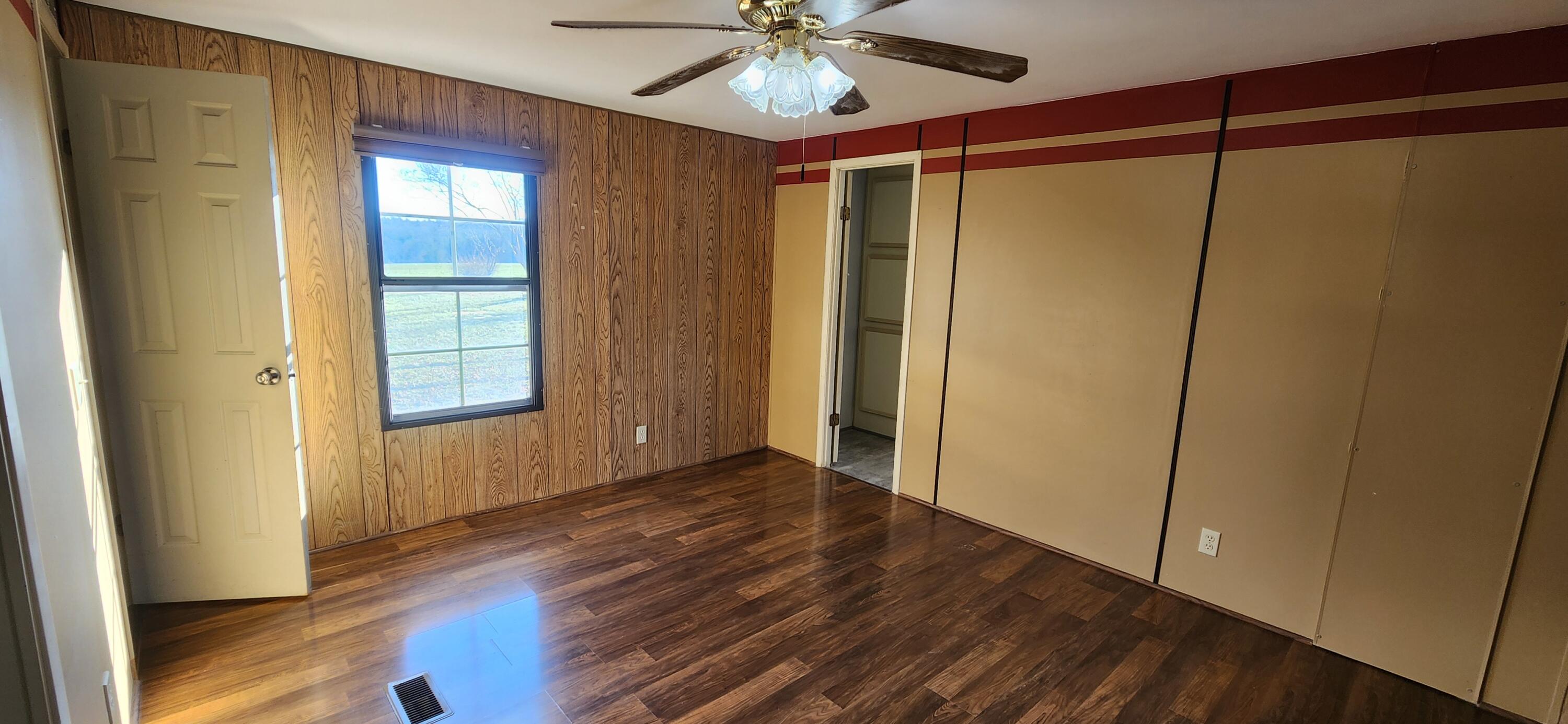 621 Kent Road Wirtz, VA 24184 - Photo 8 of 18 an empty room with wooden floor fan and windows