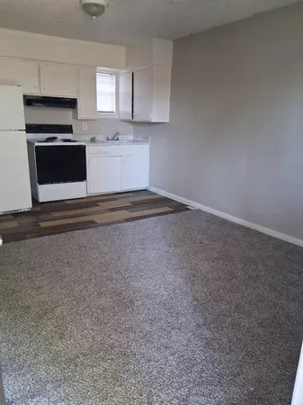 a kitchen with stainless steel appliances a sink a stove a microwave and cabinets