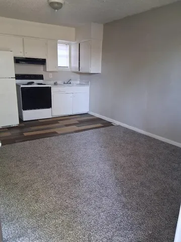 a kitchen with stainless steel appliances a sink a stove a microwave and cabinets