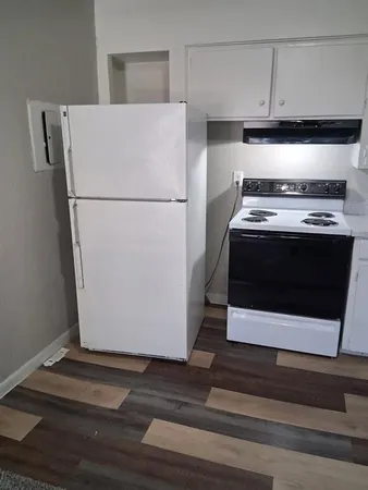 a stove top oven sitting inside of a kitchen