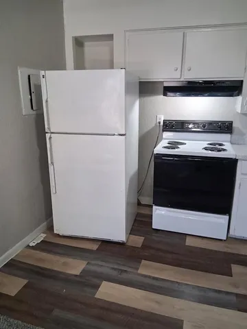 a stove top oven sitting inside of a kitchen