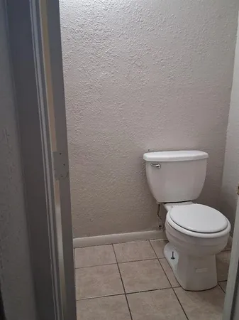 a white toilet sitting next to a shower