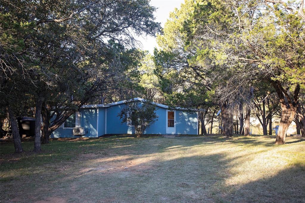 9051 Lacy Road Graford, TX 76449 - Photo 4 of 23 a view of large yard with large trees