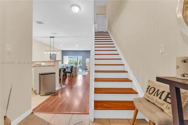 a view of entryway and hall with wooden floor