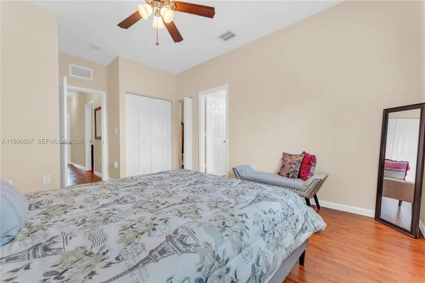a bedroom with a bed and a chandelier