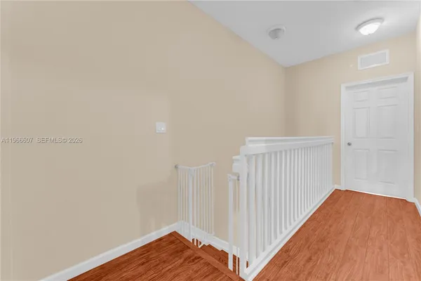 a view of a room with wooden floor