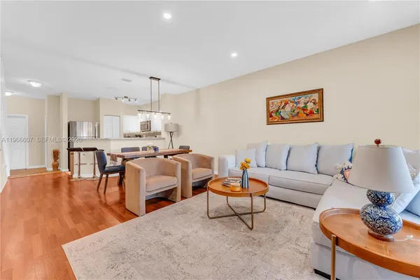 a living room with furniture and a wooden floor