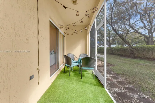 a backyard of a house with table and chairs