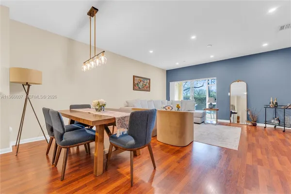 a view of a dining room with furniture window and wooden floor