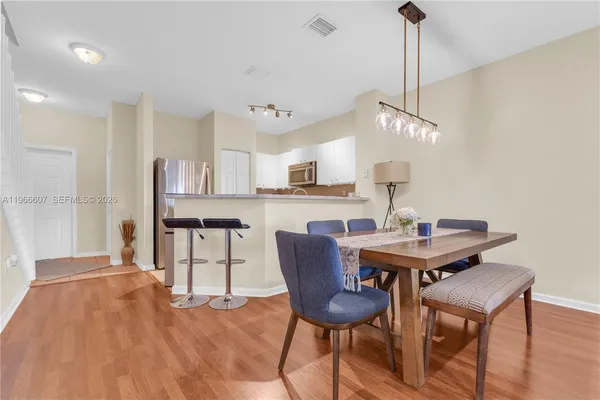 a view of a dining room with furniture and wooden floor