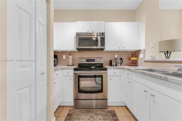 a kitchen with a sink and steel appliances