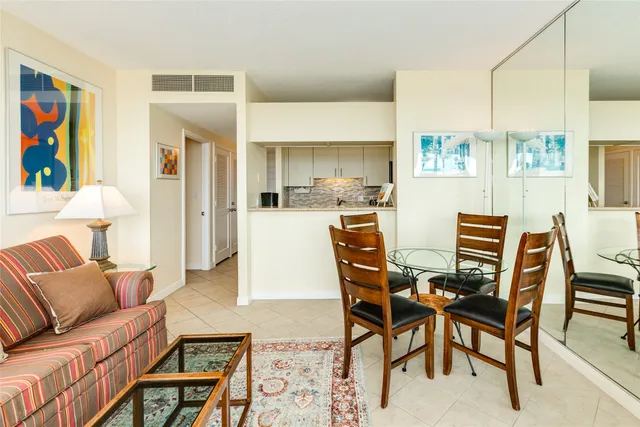 a living room with furniture and a painting on the wall