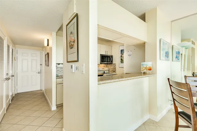 a view of kitchen with furniture and refrigerator
