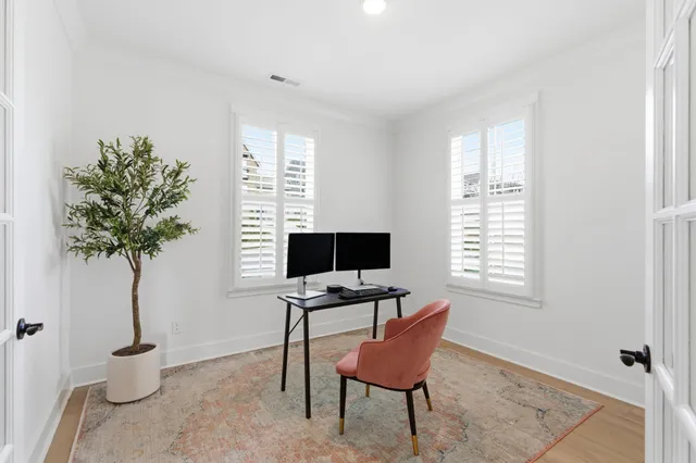 a view of a workspace with furniture and a window
