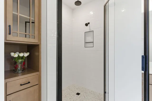 a spacious bathroom with a double vanity sink double mirror and bathtub
