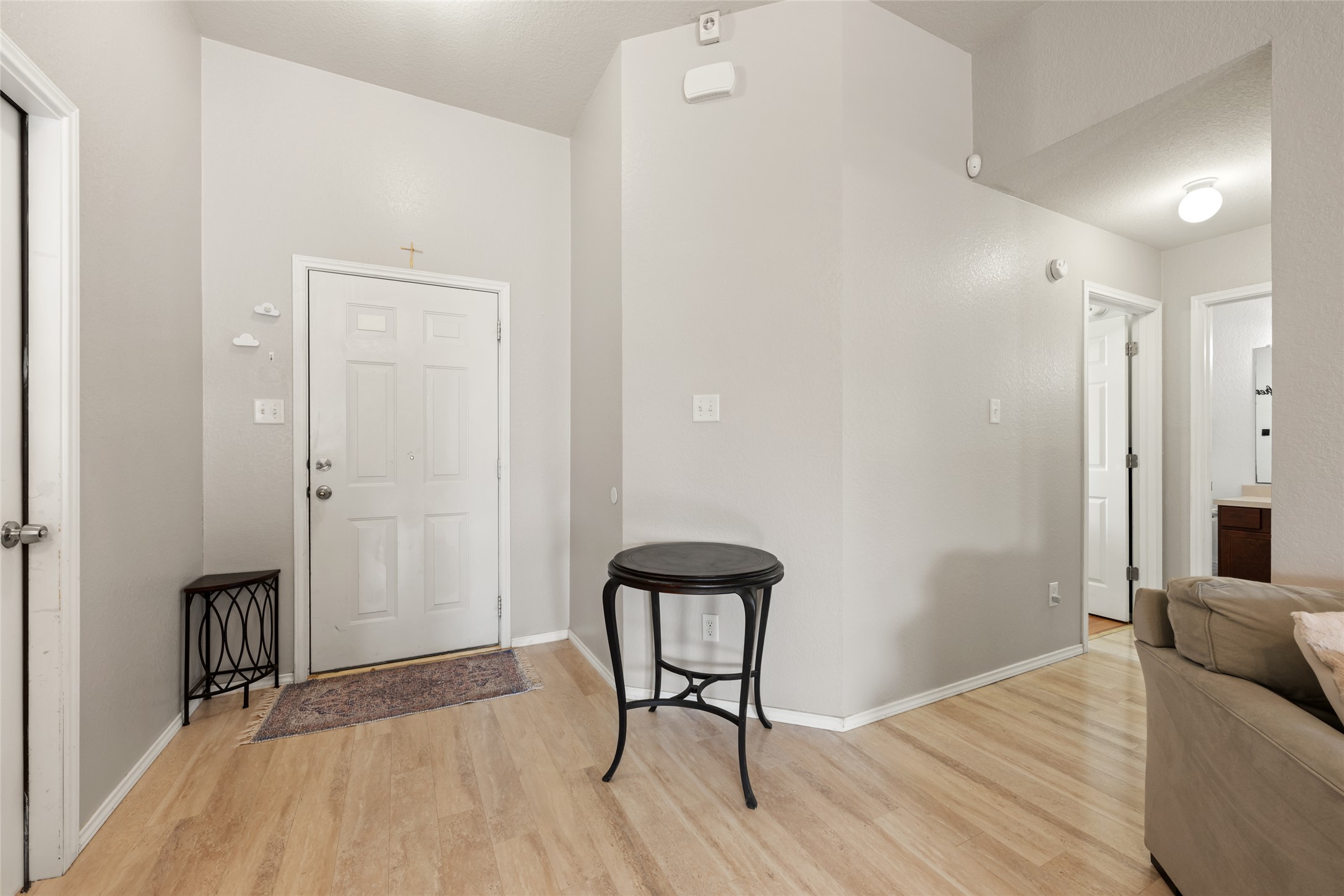 144 Calcite Lane Jarrell, TX 76537 - Photo 6 of 38 Enter into a welcoming hallway featuring high ceilings and durable wood flooring.