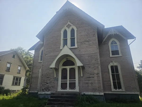 a view of a brick house with many windows