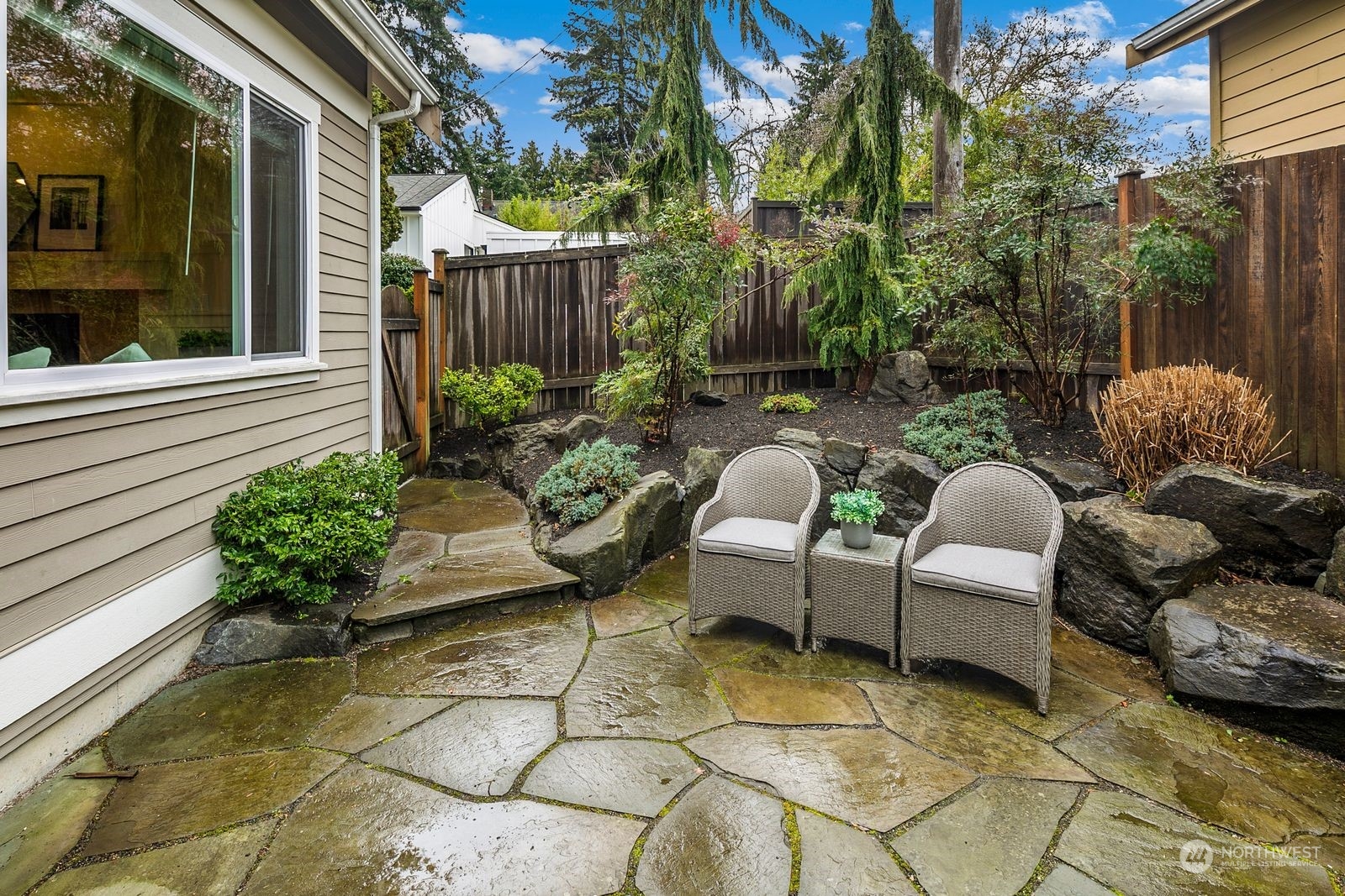 3616 Northeast 65th Street Seattle, WA 98115 - Photo 12 of 40 a view of a chairs and table in the back yard of the house