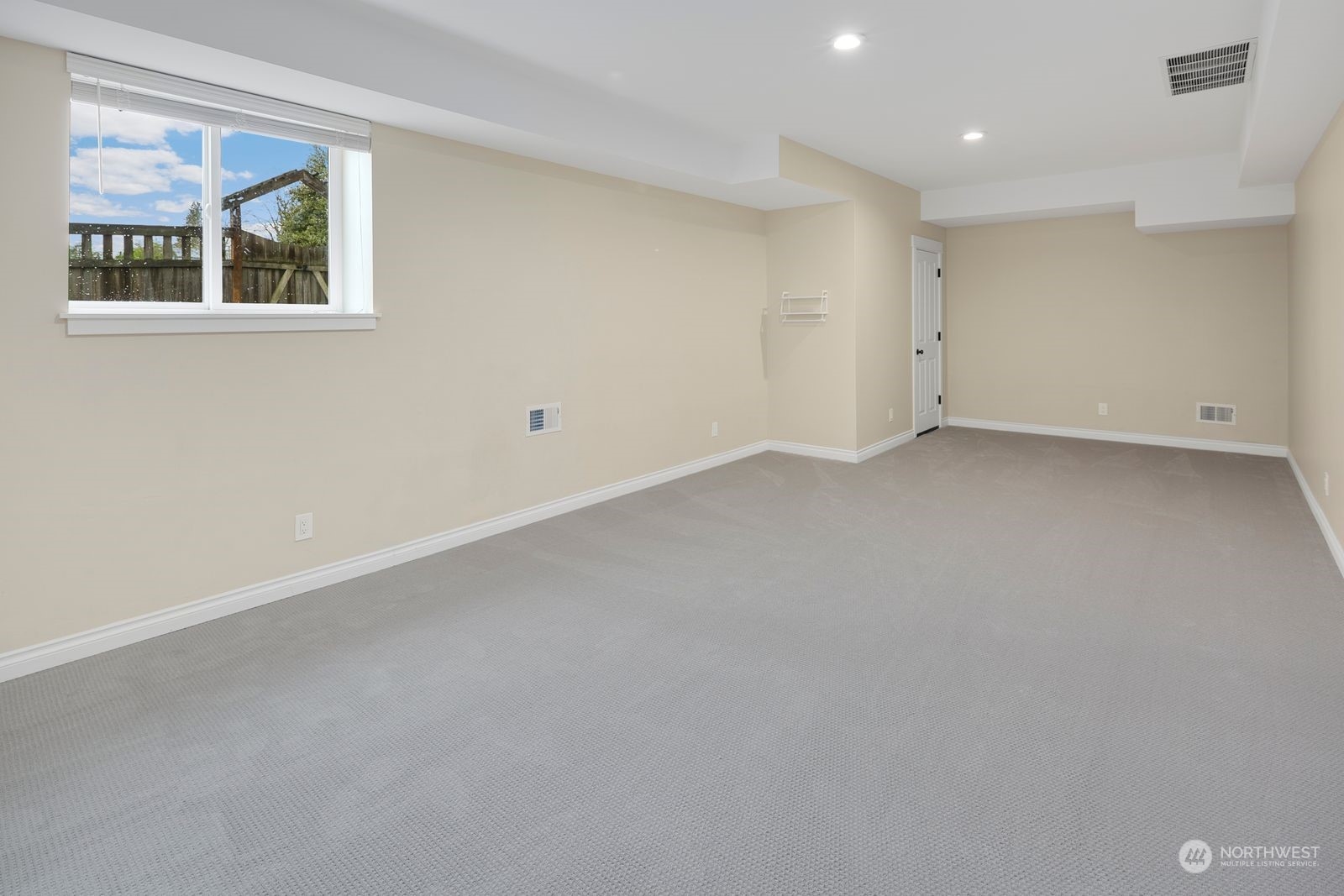 3616 Northeast 65th Street Seattle, WA 98115 - Photo 34 of 40 a view of a big room with wooden floor and windows