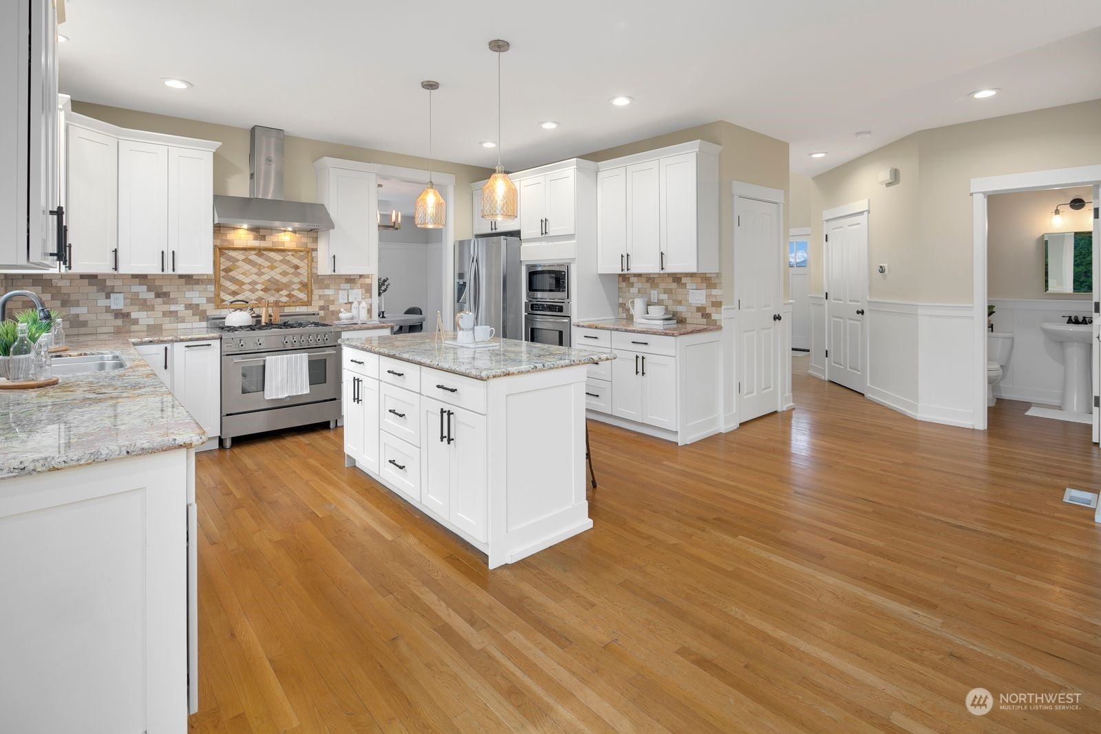 3616 Northeast 65th Street Seattle, WA 98115 - Photo 8 of 40 a large kitchen with stainless steel appliances granite countertop a stove and a sink
