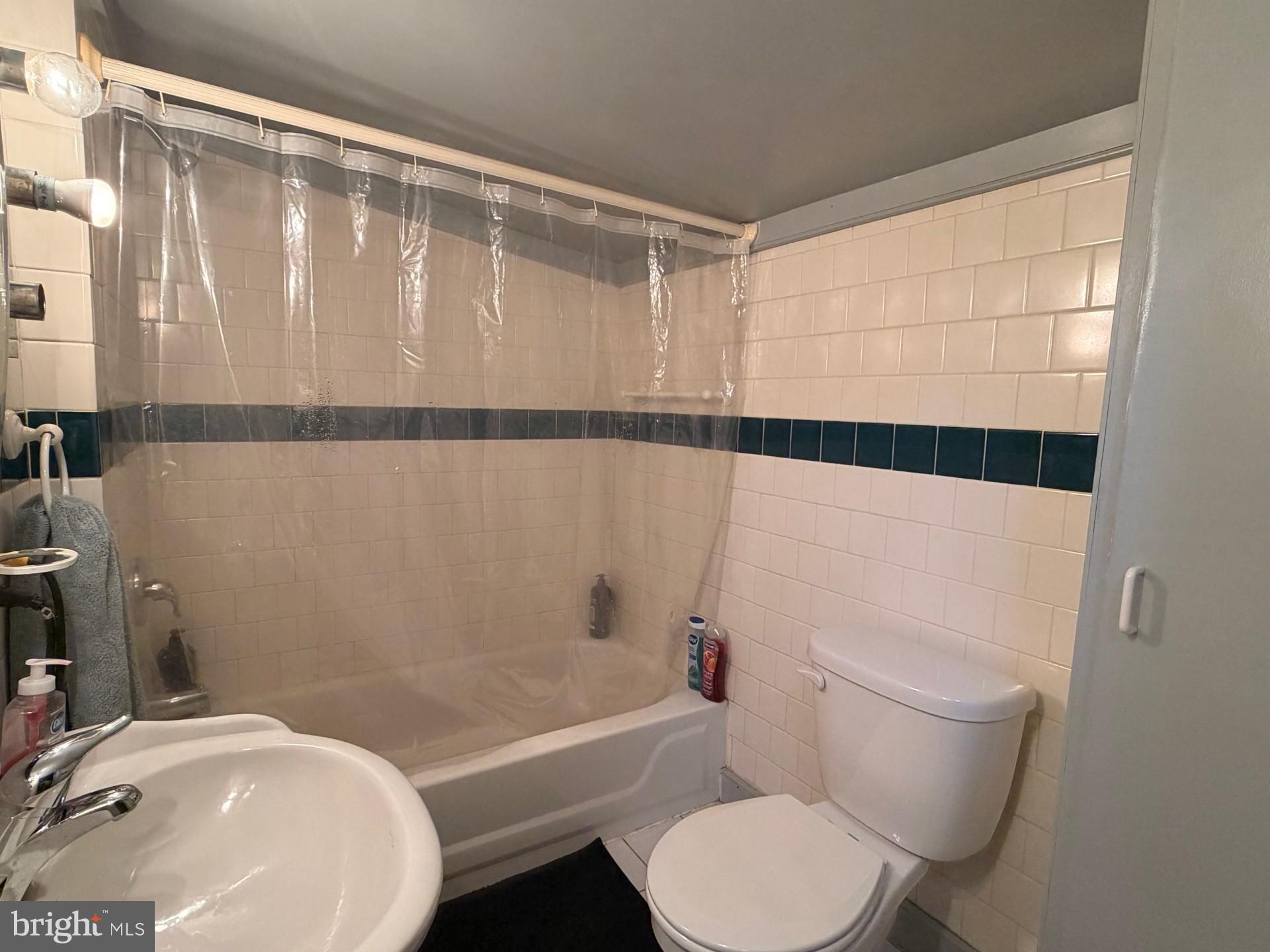 4312 Fissels Church Road Glen Rock, PA 17327 - Photo 3 of 4 a white toilet sitting next to a bathroom sink and a tub