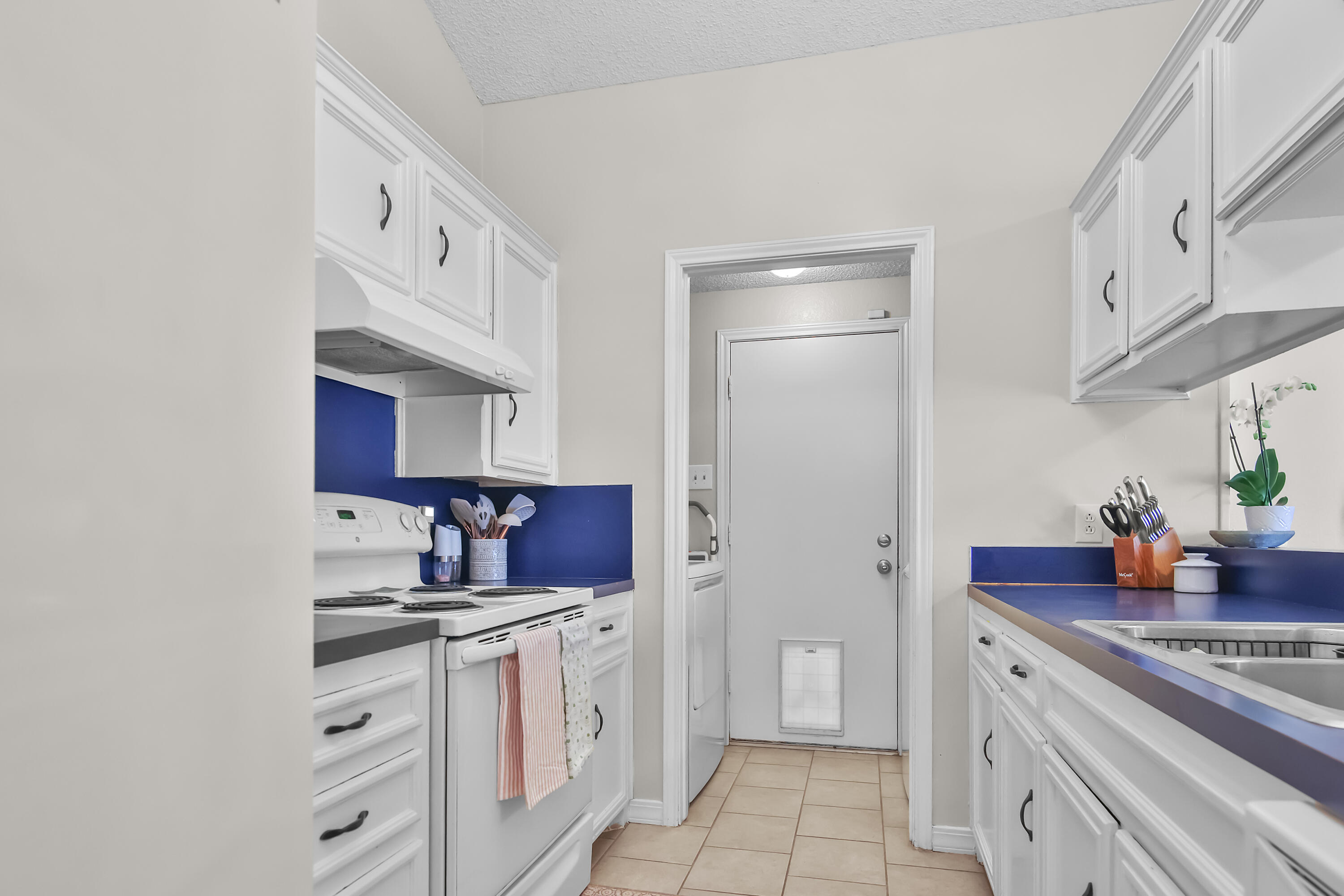 2216 86th Street Lubbock, TX 79423 - Photo 13 of 36 a kitchen with stainless steel appliances a sink stove and cabinets