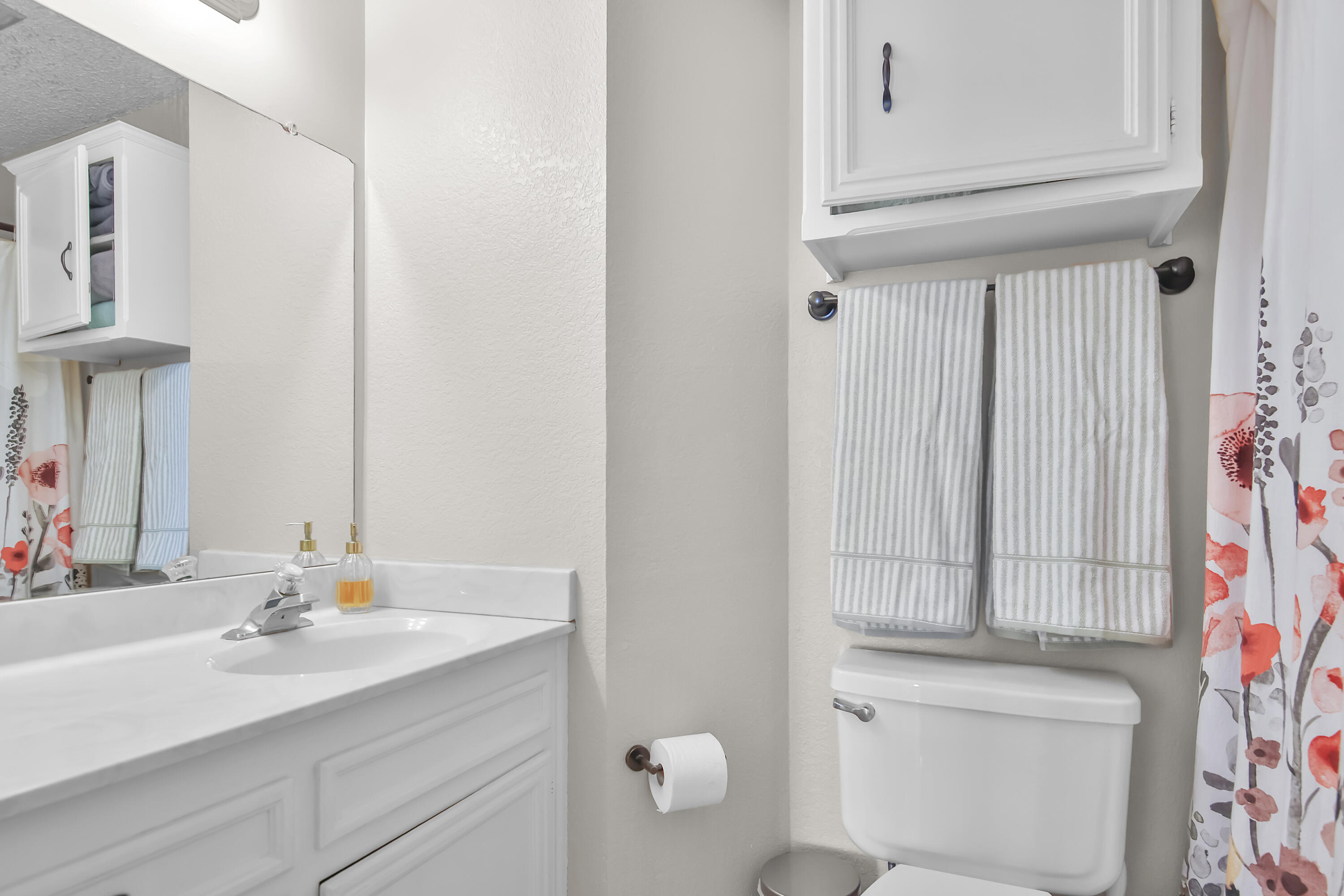 2216 86th Street Lubbock, TX 79423 - Photo 16 of 36 a bathroom with a sink vanity and a mirror