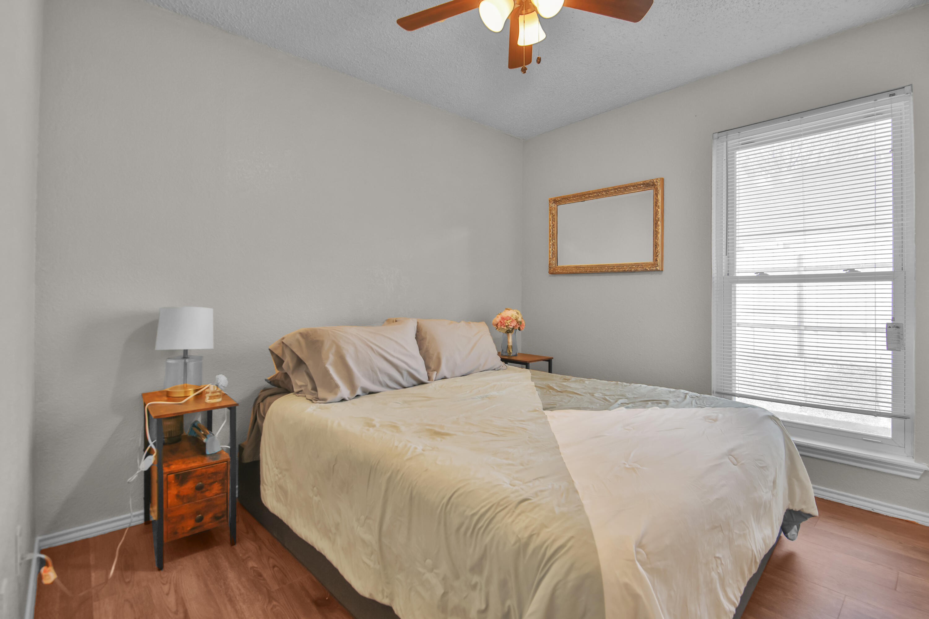 2216 86th Street Lubbock, TX 79423 - Photo 20 of 36 a bedroom with a bed and a chandelier