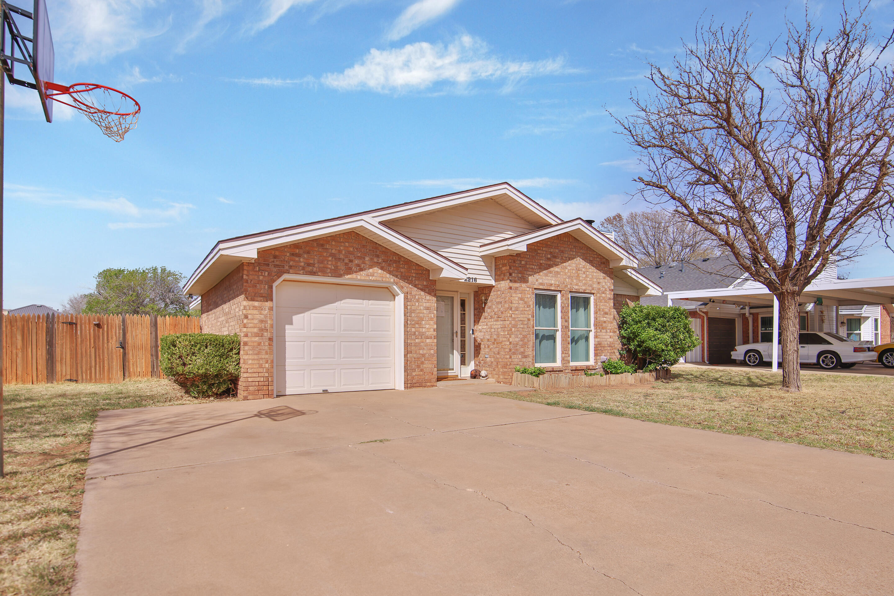 2216 86th Street Lubbock, TX 79423 - Photo 2 of 36 a front view of a house with a yard and garage