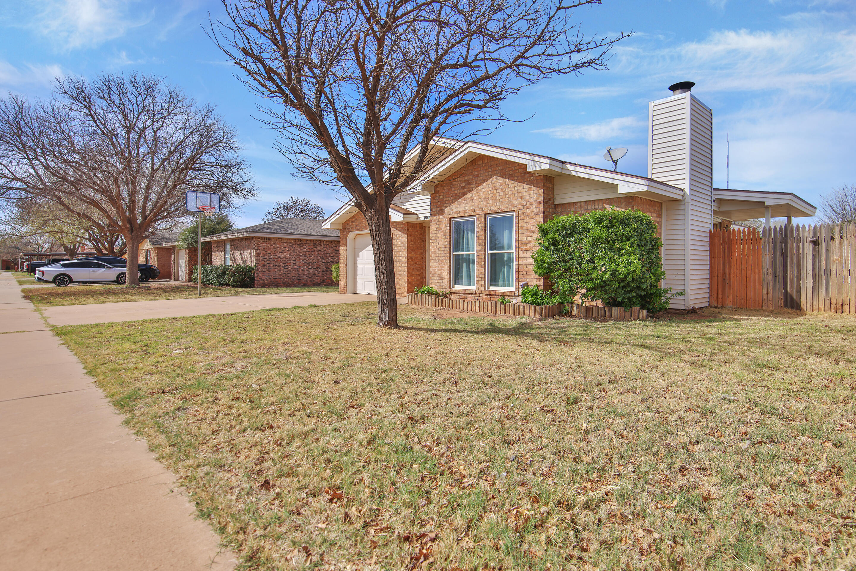 2216 86th Street Lubbock, TX 79423 - Photo 3 of 36 a front view of a house with a yard and fountain