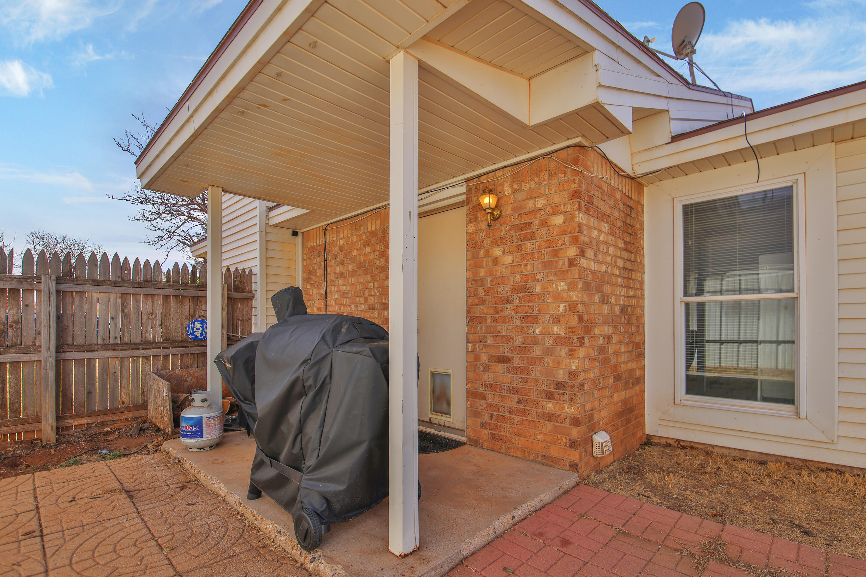 2216 86th Street Lubbock, TX 79423 - Photo 32 of 36 a view of a door and chair in the patio