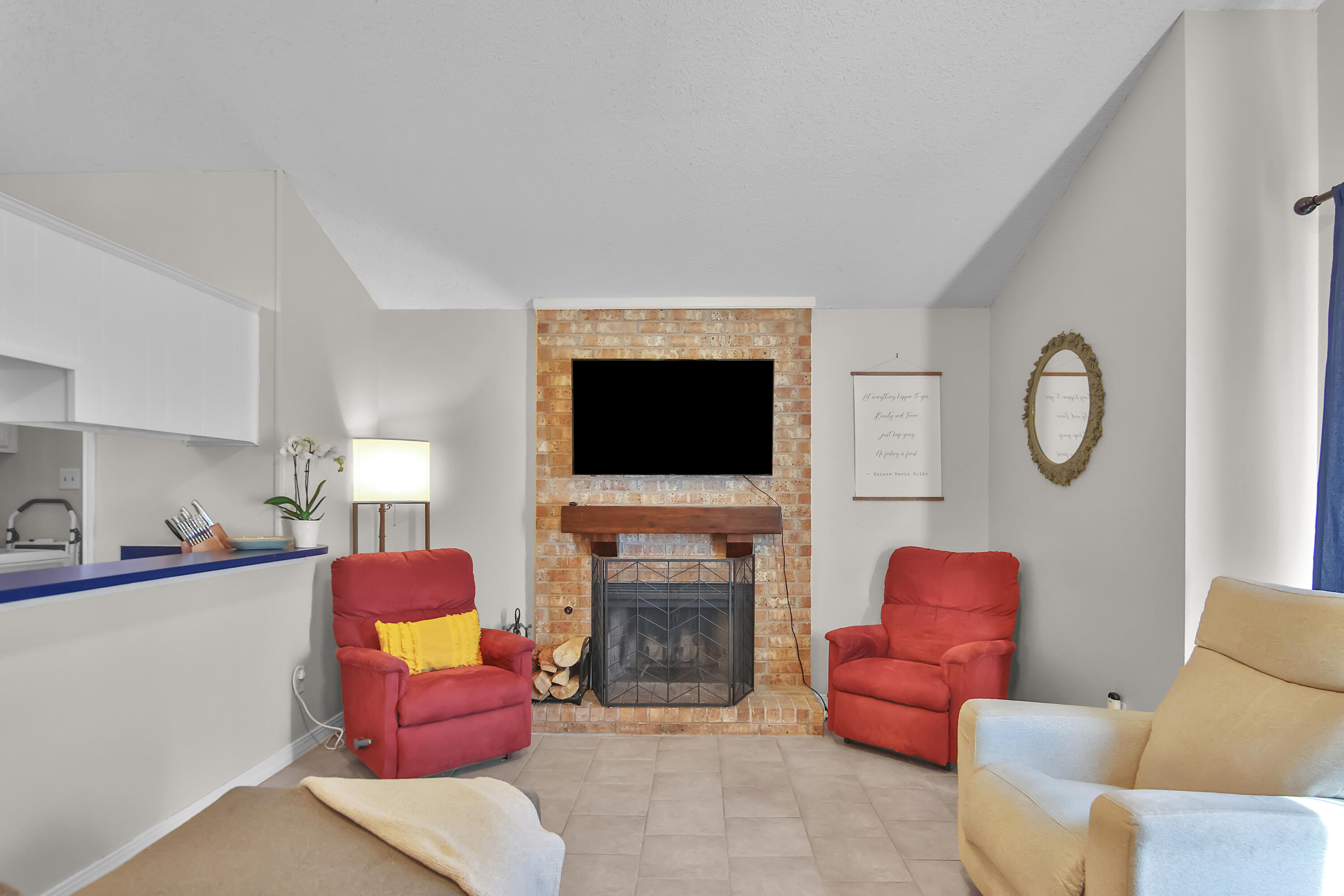 2216 86th Street Lubbock, TX 79423 - Photo 5 of 36 a living room with furniture a flat screen tv and a fireplace