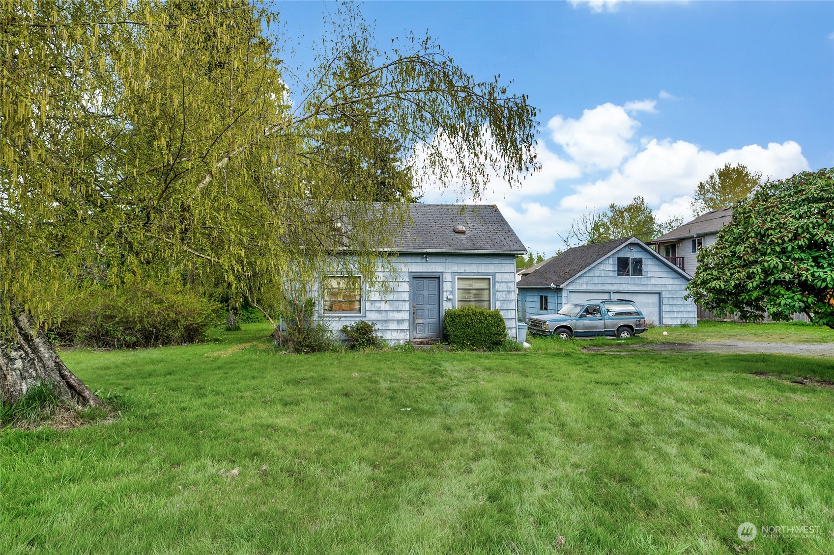 a front view of a house with a garden