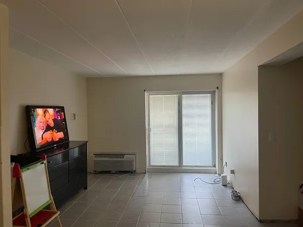 a view of room with furniture and flat screen tv