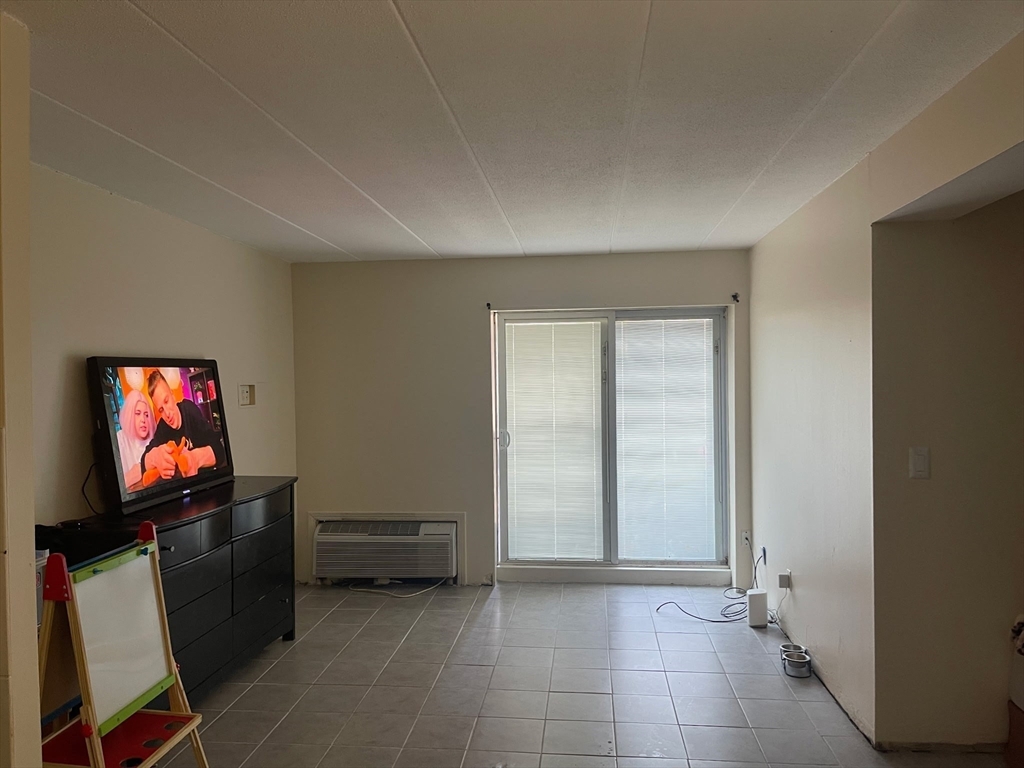 126 Beaver Street, Unit 56 Framingham, MA 01702 - Photo 4 of 8 a view of room with furniture and flat screen tv