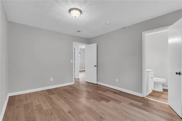 a view of room with wooden floor and a ceiling fan