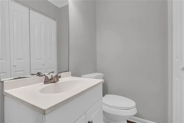 a bathroom with a sink a toilet and mirror