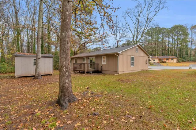 a view of a house with a yard and garage