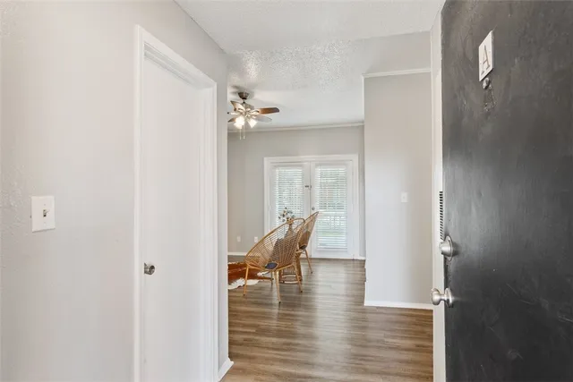 a view of a room with wooden floor lounge chair and windows