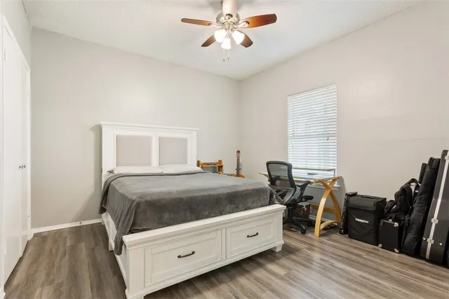 a bedroom with a bed and wooden floor