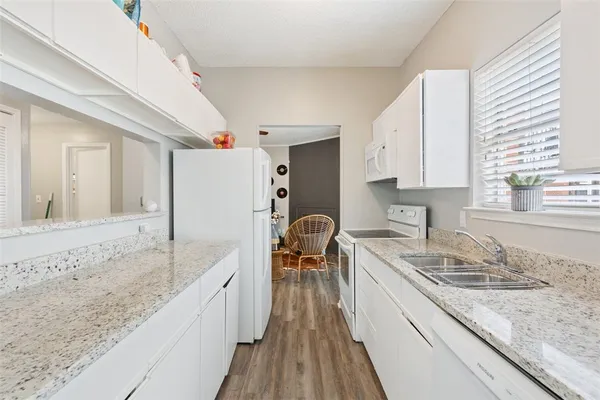 a kitchen with a sink stove and cabinets
