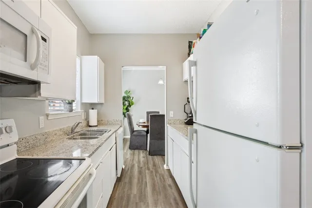 a kitchen with a sink stove and refrigerator