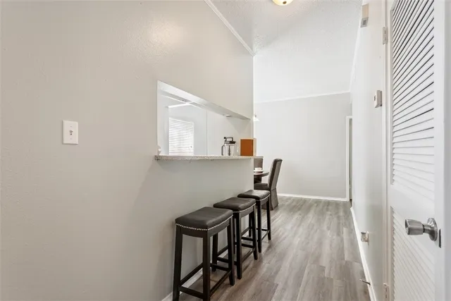 a view of a workspace with furniture and wooden floor
