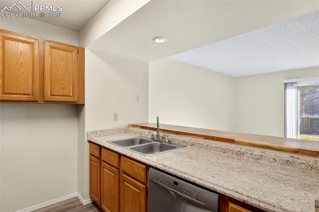 a kitchen with a sink cabinets and a window