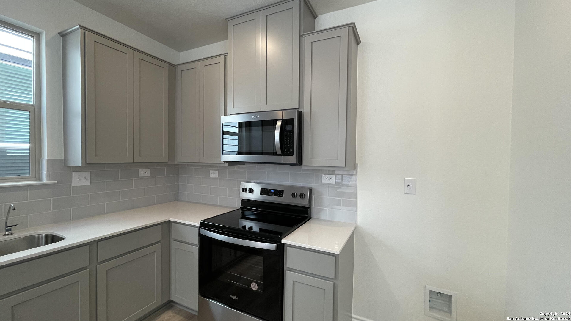 14839 Vance Jackson Road, Unit 606 San Antonio, TX 78249 - Photo 2 of 13 a kitchen with a sink and a stove top oven